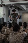 U.S. Marine Corps Sgt. Natali Moreno, a drill instructor with Receiving Company, Support Battalion, briefs the new recruits with Lima Company, 3rd Recruit Training Battalion, prior to meeting their drill instructors as part of a pick-up event at Marine Corps Recruit Depot San Diego, California, Oct. 25, 2024. Pick-up day signifies the first official day of training in which recruits will meet their drill instructor team for the first time, prepare their gear and squad bay, and expectations are set for the remainder of their time in recruit training. (U.S. Marine Corps photo by Cpl. Alexandra M. Earl)