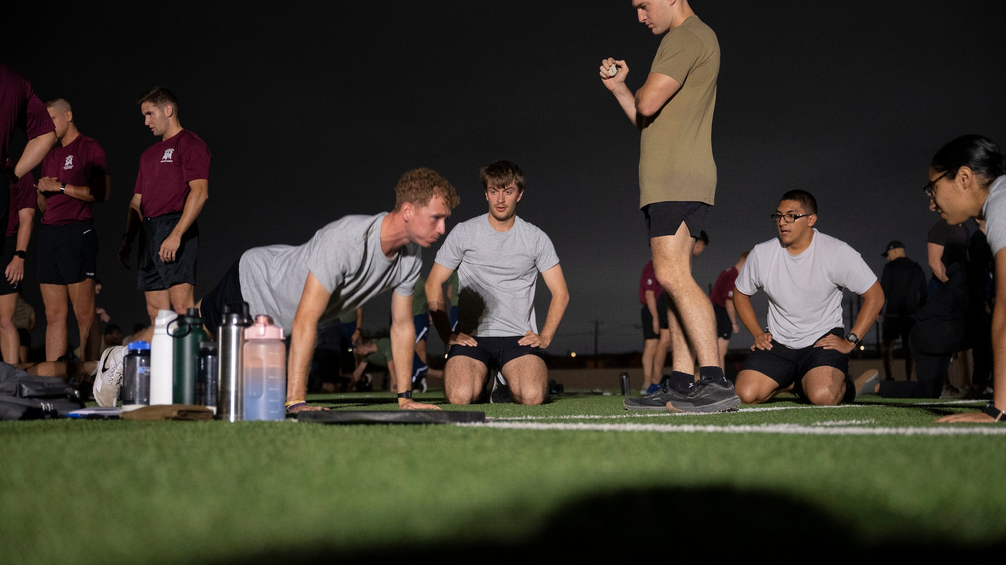 AFROTC cadets work together to get as many push ups as they can in two minutes