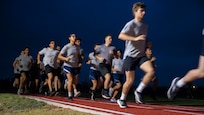 AFROTC cadets run on a track in a 2 mile race