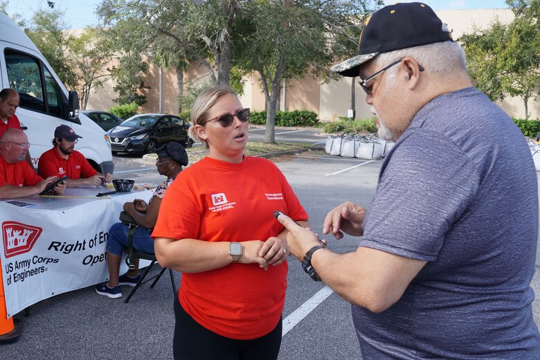 Katie Blanton, St. Louis District talks with a resident about the U.S. Army Corps of Engineers Blue Roof mission in Orange City, Florida. Blanton is deployed to Florida as part of Operation Blue Roof in response to Hurricane Milton.  (USACE photo by Mark Rankin)