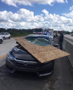 A piece of plywood flew off a truck and smashed through this car’s windshield on Interstate 95 near Rockledge, Fla., but miraculously, no one was injured. Unsecured items can become lethal flying debris when driving, especially at higher speeds on highways.