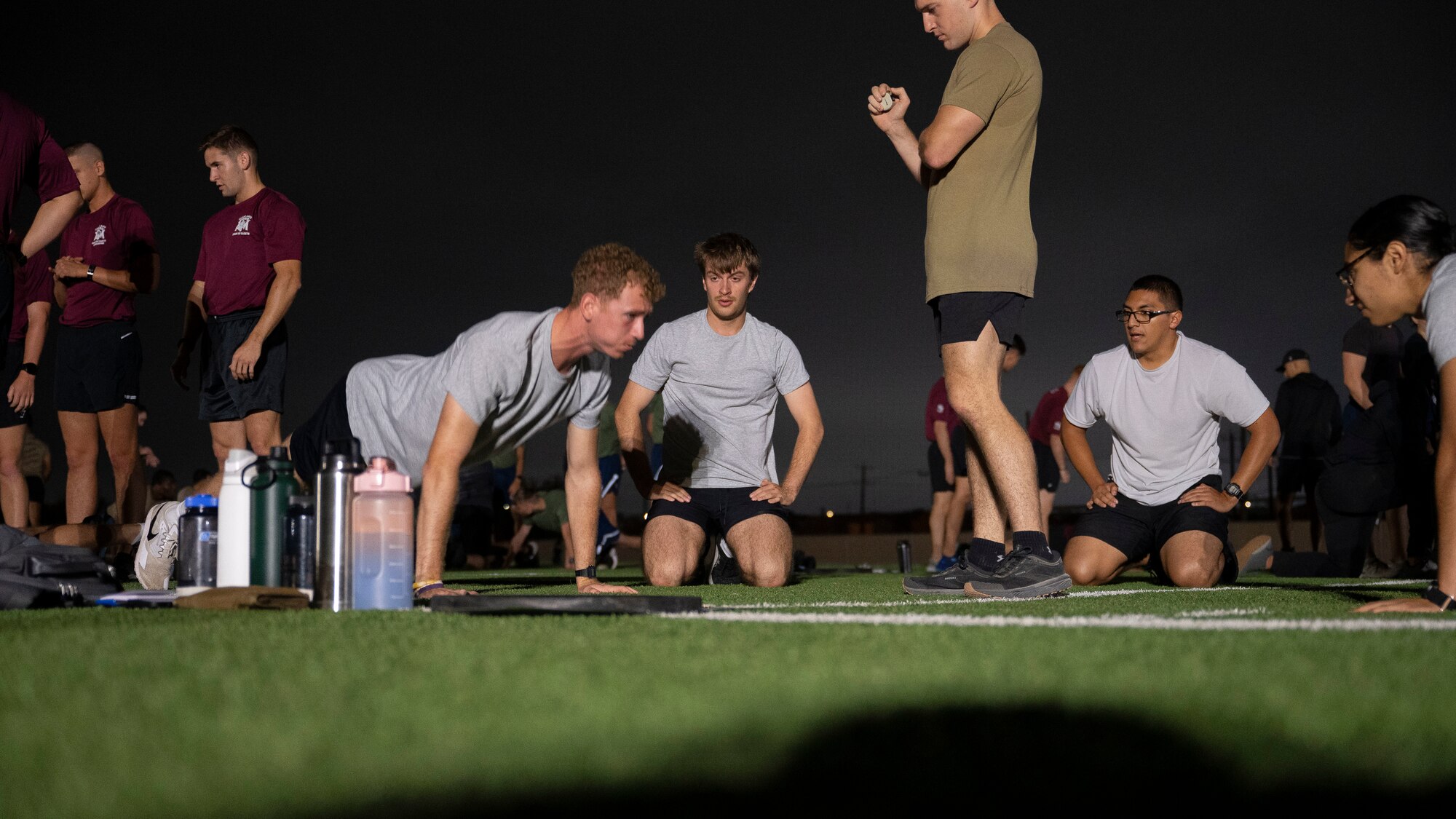AFROTC cadets work together to get as many push ups as they can in two minutes