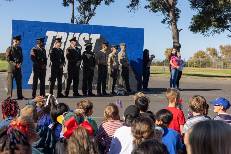 U.S. Marines with Marine Air Control Squadron (MACS-1), Marine Air Control Group 38, Tactical Air Command Center (TACC) Company, 3rd Marine Aircraft Wing , attend a ceremony for the annual Veterans Day program at Sunset Hills Elementary School, San Diego, Nov. 7, 2024. The event featured active-duty Marines who presented equipment and engaged with students and parents about their military service. (U.S. Marine Corps photo by Sgt. Santicia Ambriez-Stippey)