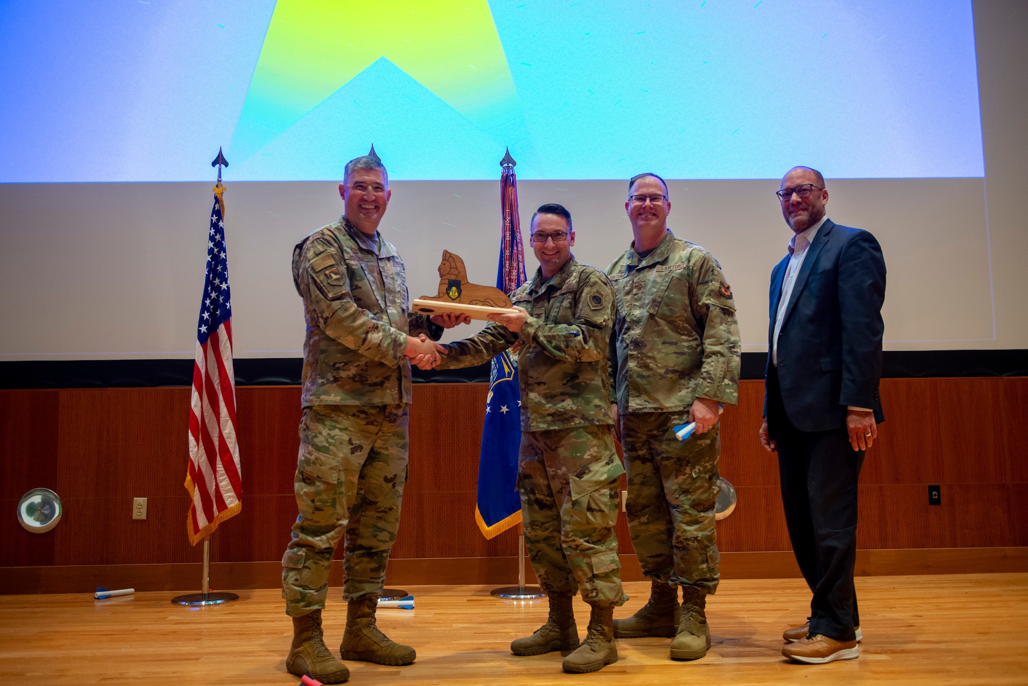 Col. Ryan Skaggs, center left, receives the NASIC spirt award from Col. Kenneth Stremmel, left, Chief Master Sgt. David Southall, center right, and Duane Harrison, right.