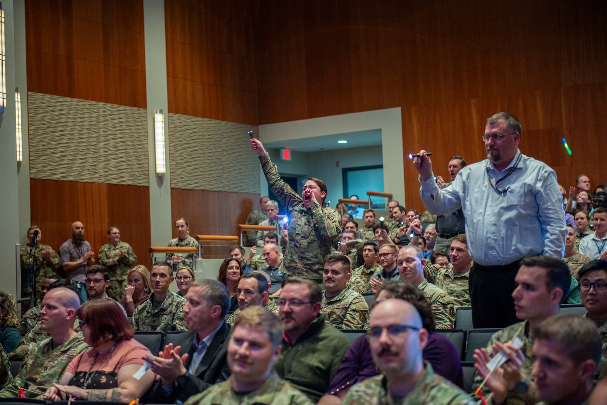 Members of the Networked Weapons and Modeling Group celebrate as a member of their team wins a quarterly award.