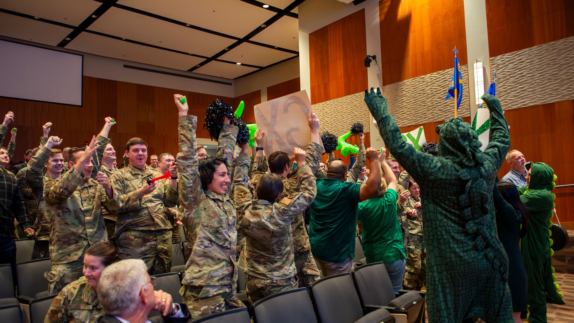 Members of the Global Exploitation Intelligence Group celebrate as a member of their team wins a quarterly award.