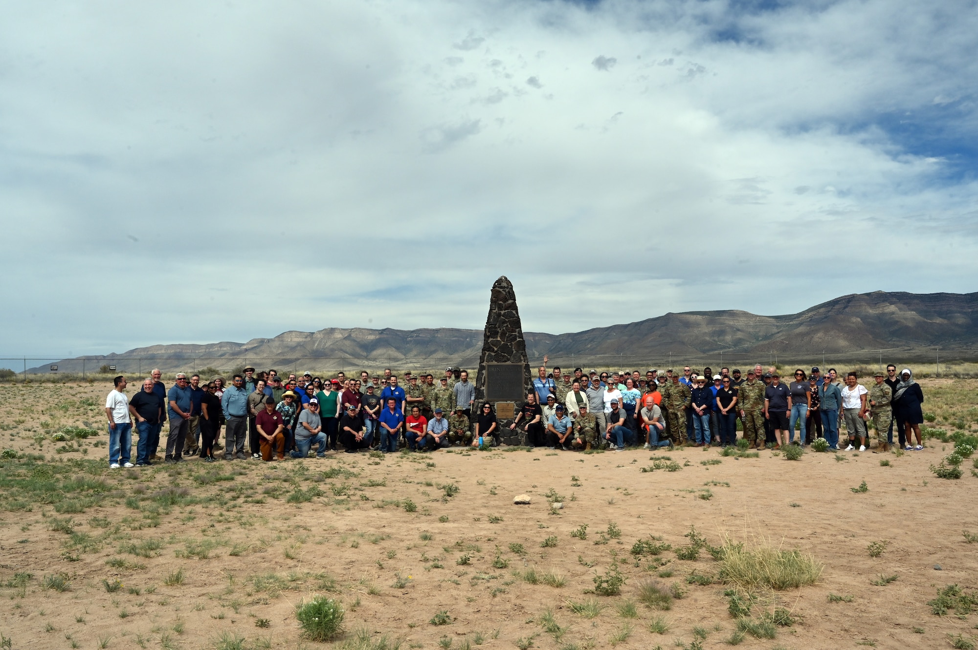 Large group of people in front of historical marker