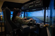 U.S. Air Force Staff Sgt. Kristine Legate, Misawa American Forces Network producer, operates a heavy vehicle snow operations simulator