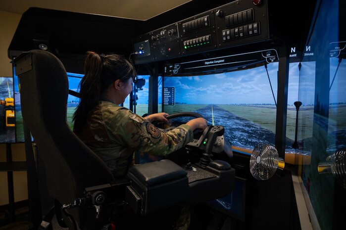 U.S. Air Force Staff Sgt. Kristine Legate, Misawa American Forces Network producer, operates a heavy vehicle snow operations simulator