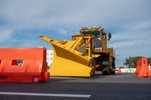 A rollover plow prepares for the obstacle course during the Snow Rodeo
