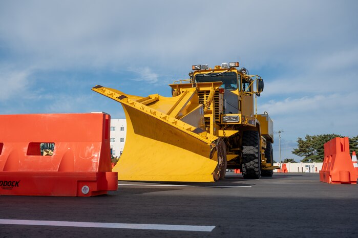 A rollover plow prepares for the obstacle course during the Snow Rodeo
