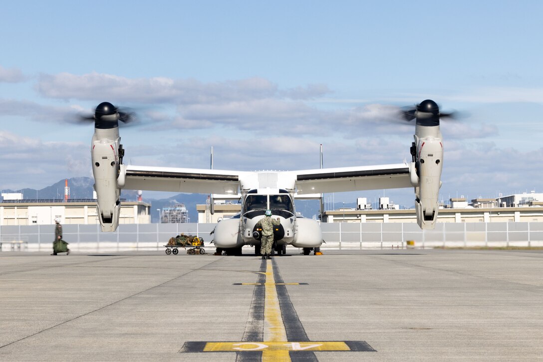 Aviation Electronics Technician 2nd Class Liam Perez, a native of California, assigned to Fleet Logistics Multi-Mission Squadron (VRM) 30, Detachment Forward Deployed Naval Forces (FDNF), watches for hazards as a U.S. Navy CMV-22B Osprey with VRM-30 is loaded with supplies at Marine Corps Air Station (MCAS) Iwakuni, Japan, Nov. 7, 2024. The VRM-30 detachment is part of Carrier Air Wing (CVW) 5 embarked on Nimitz-class aircraft carrier USS George Washington (CVN-73). VRM-30 is part of Carrier Air Wing (CVW) 5 embarked on Nimitz-class aircraft carrier USS George Washington (CVN-73). George Washington is 7th Fleet’s premier forward deployed aircraft carrier, a long-standing symbol of the United States’ commitment to maintaining a free and open Indo-Pacific region, while operating alongside allies and partners across the U.S. Navy’s largest forward-deployed numbered fleet. (U.S. Marine Corps photo by Cpl. Brian Long)