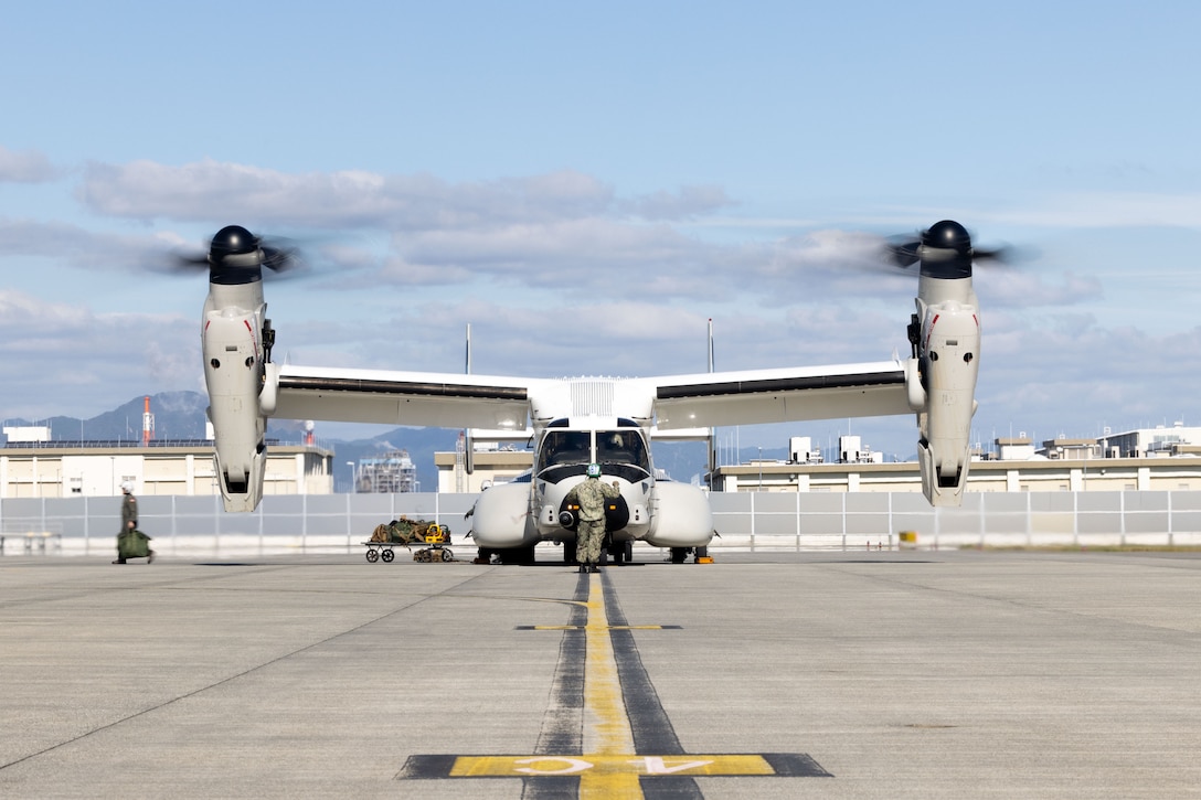 Aviation Electronics Technician 2nd Class Liam Perez, a native of California, assigned to Fleet Logistics Multi-Mission Squadron (VRM) 30, Detachment Forward Deployed Naval Forces (FDNF), watches for hazards as a U.S. Navy CMV-22B Osprey with VRM-30 is loaded with supplies at Marine Corps Air Station (MCAS) Iwakuni, Japan, Nov. 7, 2024. The VRM-30 detachment is part of Carrier Air Wing (CVW) 5 embarked on Nimitz-class aircraft carrier USS George Washington (CVN-73). VRM-30 is part of Carrier Air Wing (CVW) 5 embarked on Nimitz-class aircraft carrier USS George Washington (CVN-73). George Washington is 7th Fleet’s premier forward deployed aircraft carrier, a long-standing symbol of the United States’ commitment to maintaining a free and open Indo-Pacific region, while operating alongside allies and partners across the U.S. Navy’s largest forward-deployed numbered fleet. (U.S. Marine Corps photo by Cpl. Brian Long)