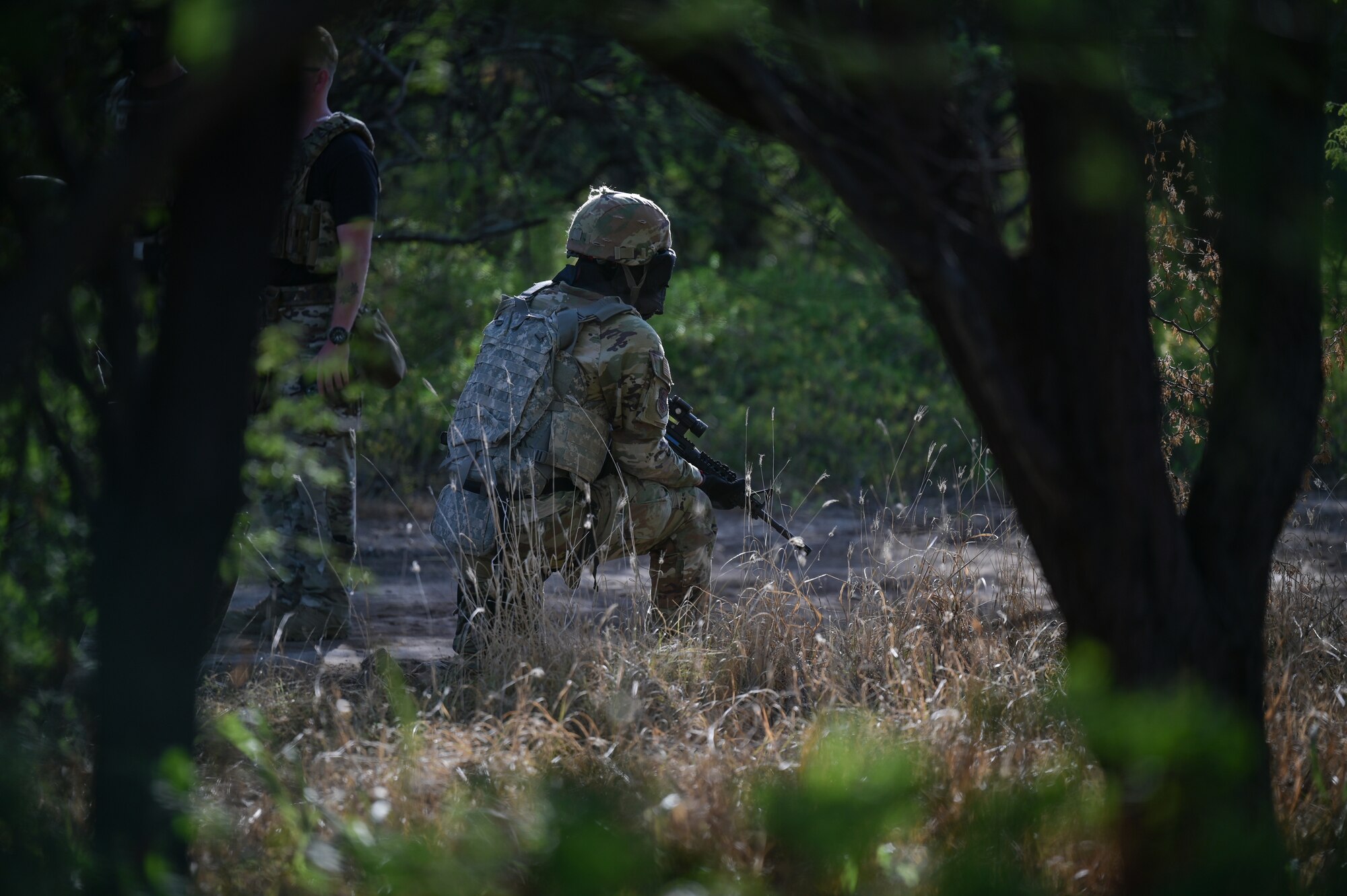 Airman carries a rifle during training exercise.