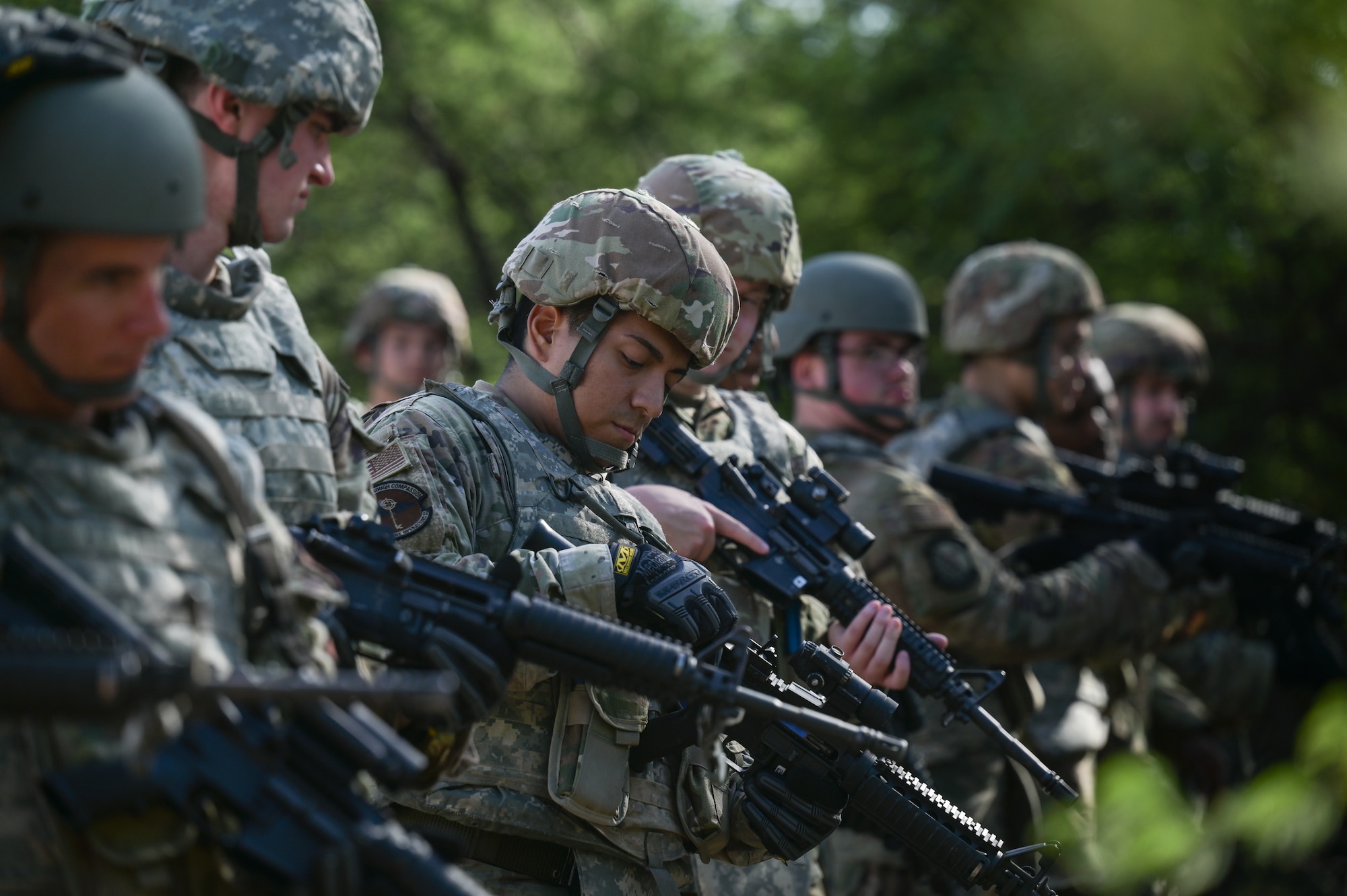 A line of Airmen carry rifles during training.