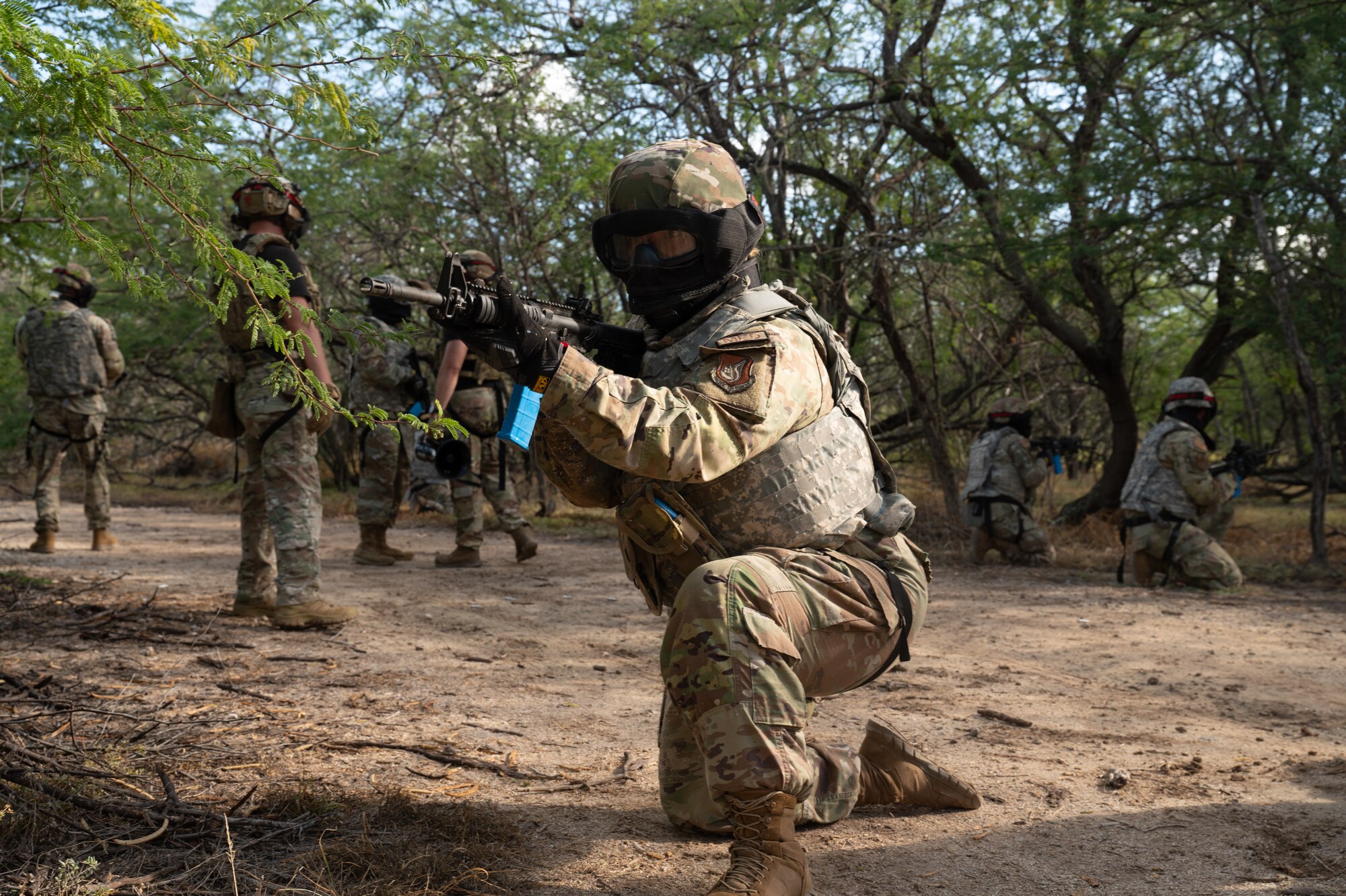 Airman points rifle during patrol.