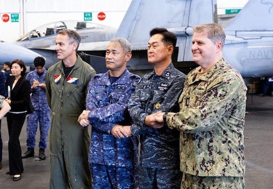 At sea, during trilateral exercise Freedom Edge, U.S. Rear Admiral Gregory D. Newkirk, Republic of Korean Rear Admiral Hur Sung-jae, Japanese Rear Admiral Takashi Matsui and U.S. Vice Admiral Fred Kacher stand together aboard USS George Washington (CVN 73).