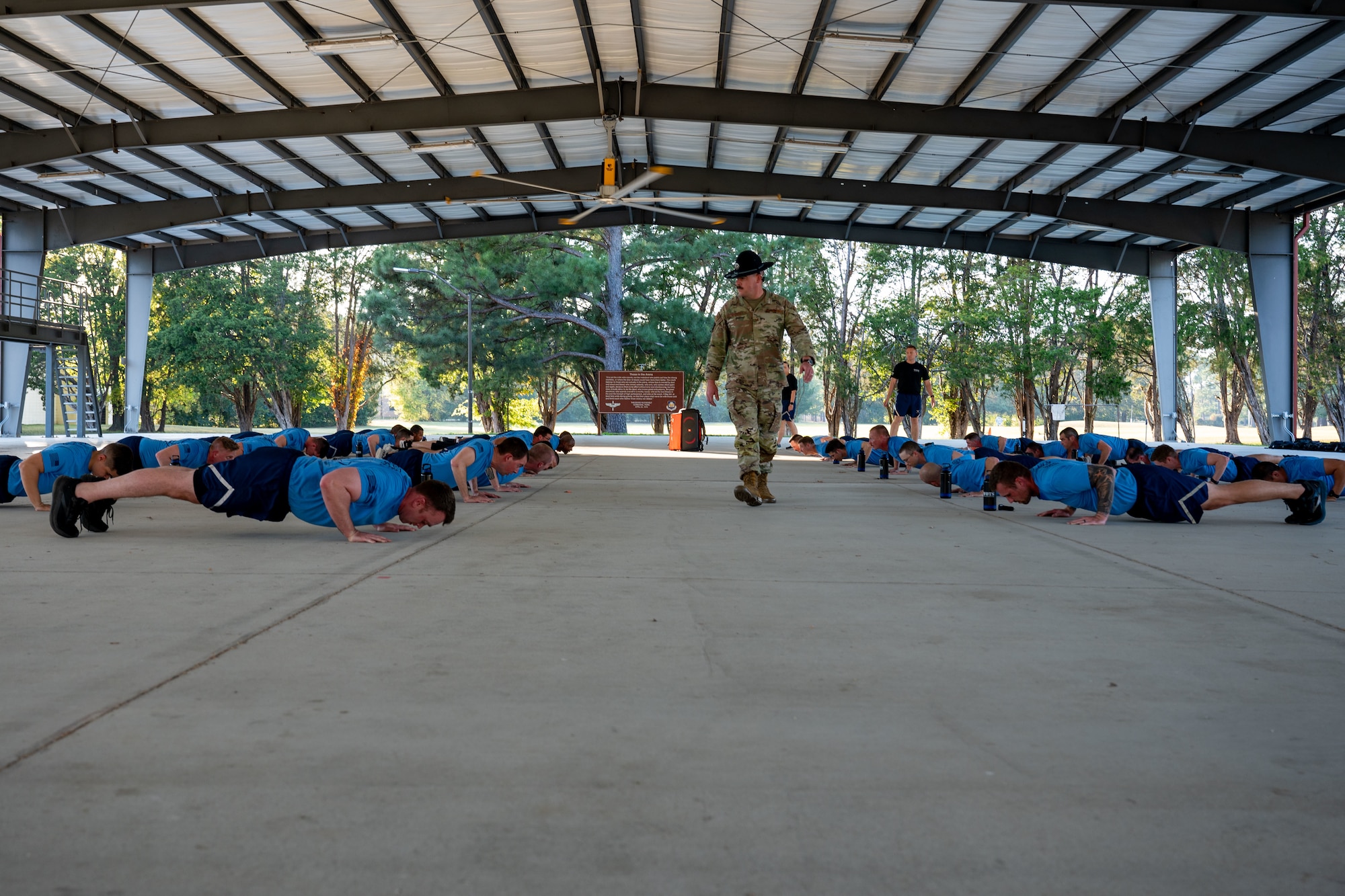 Tech. Sgt. Joseph Charron, Warrant Officer Training School military training instructor, observes Warrant Officer Training School class 25-01 as they compete in a push-up challenge at Maxwell Air Force Base, Alabama, Oct. 25, 2024.