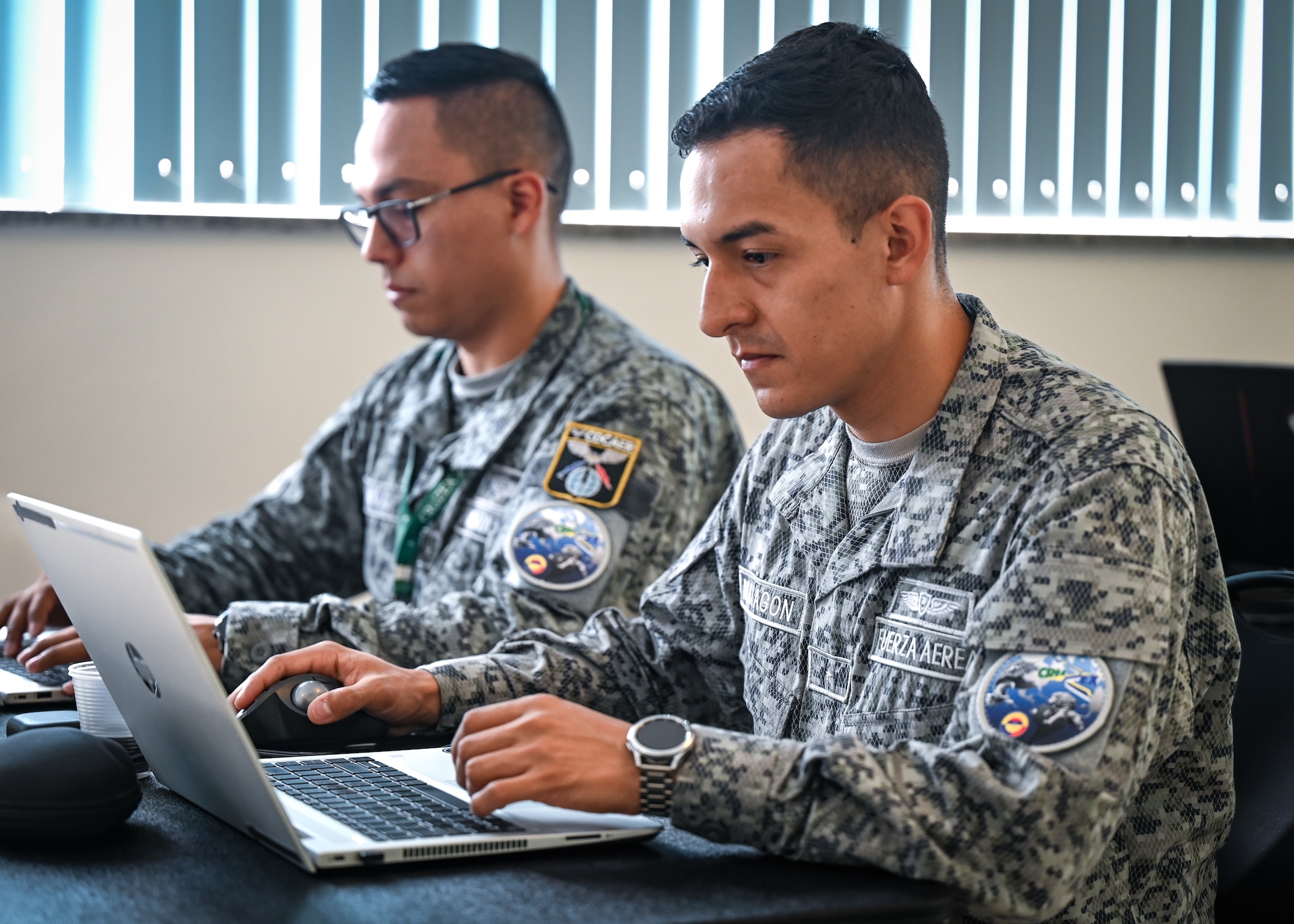 Colombian Air Force cyber technicians work through a scenario during CRUZEX CYBER 2024 at Natal Air Force Base, Brazil, Nov. 8, 2024. The training aims to fortify the resilience of critical military infrastructure and strengthen the strategic partnerships within the region. (U.S. Air Force photo by Staff Sgt. Madeline Herzog)
