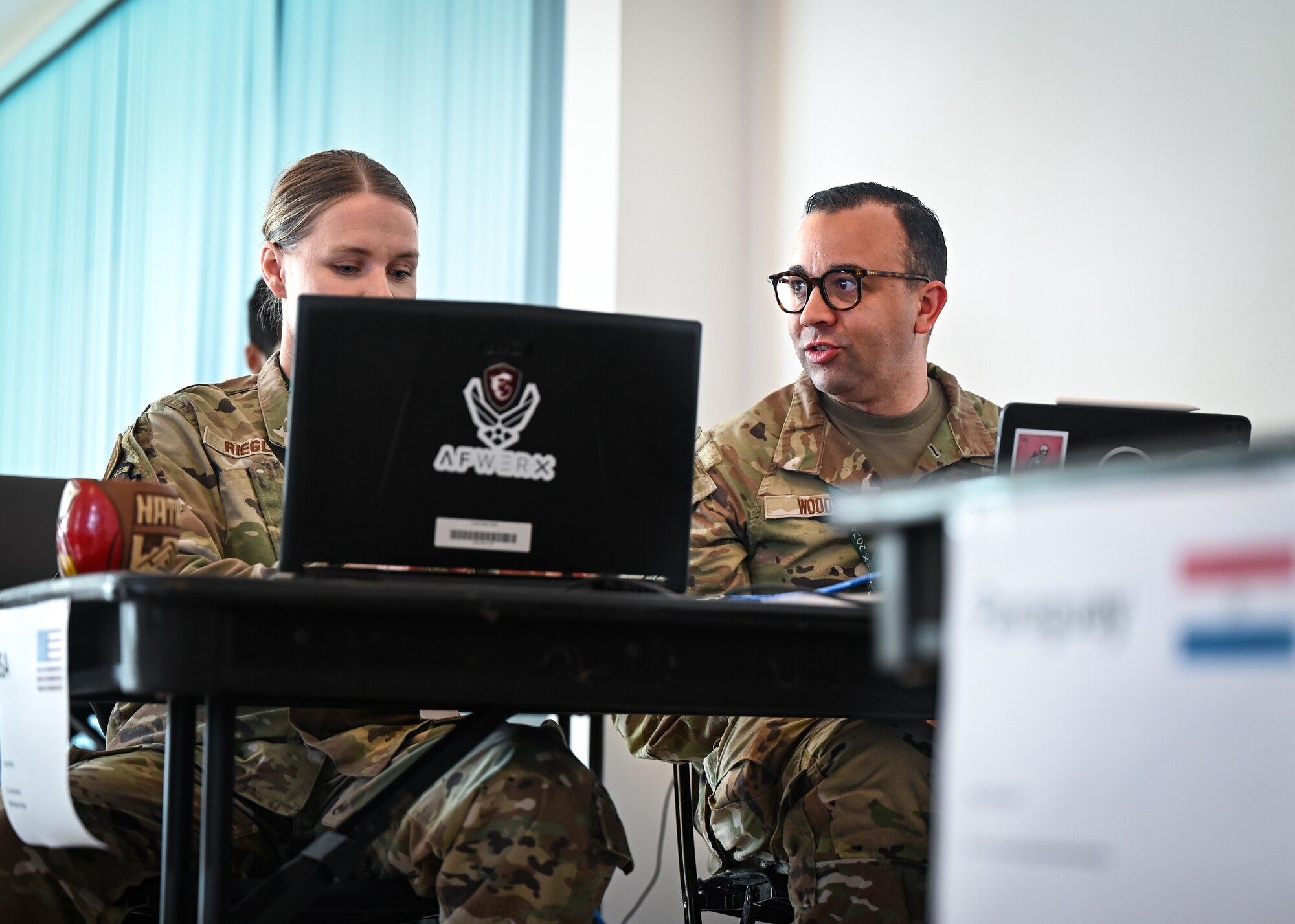 U.S. Air Force Vermont Air National Guard cyber warfare Airmen communicate for a scenario during CRUZEX CYBER at Natal Air Force Base, Brazil, Nov. 8, 2024. CRUZEX CYBER is a testament to fostering international collaboration and enhancing cybersecurity expertise across the participating nations. (U.S. Air Force photo by Staff Sgt. Madeline Herzog)