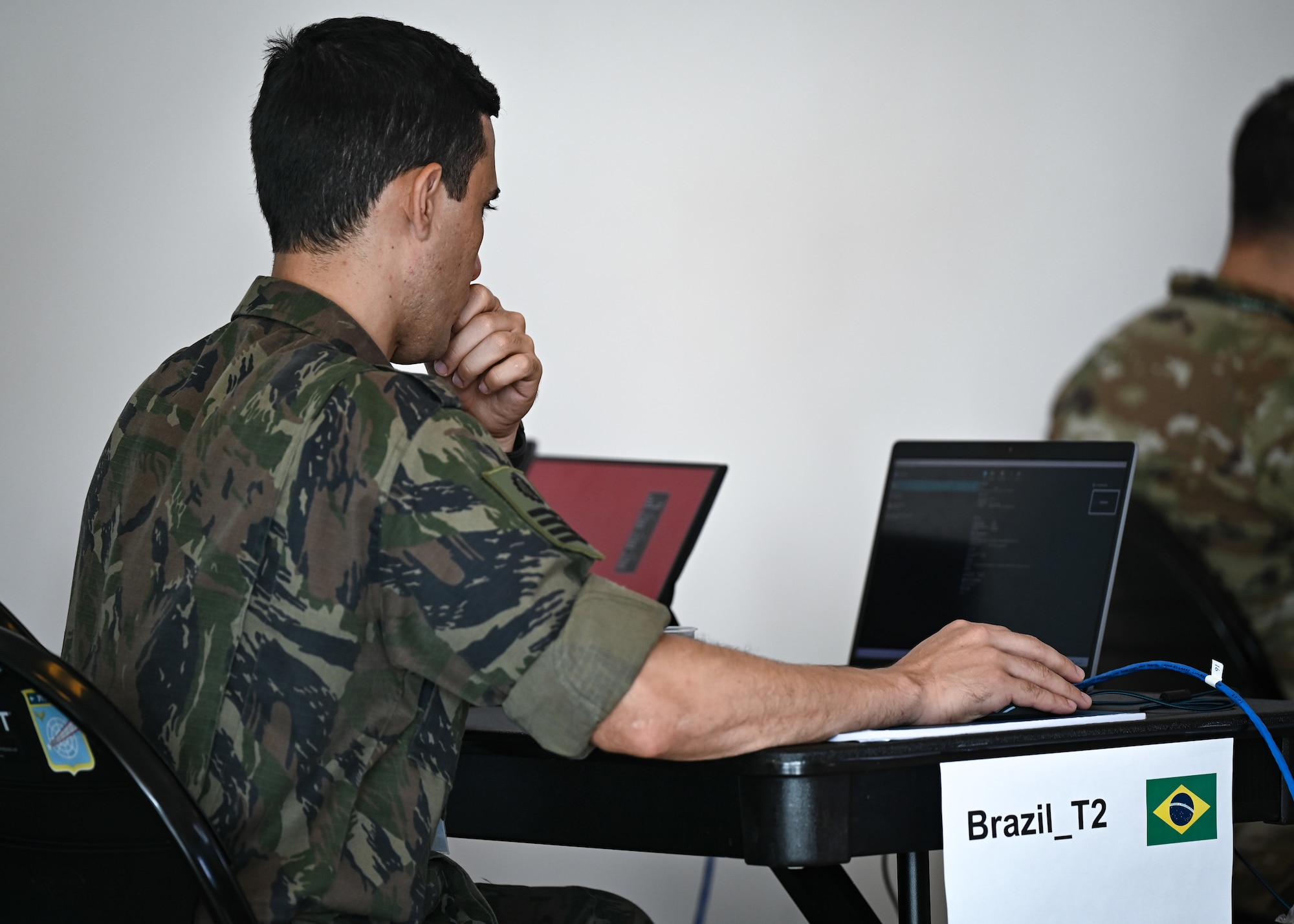 A Brazilian Air Force cyber technician participates in a scenario during CRUZEX CYBER at Natal Air Force Base, Brazil, Nov. 8, 2024. The addition of cyber scenarios aims to expand the scope of the exercise by highlighting the crucial intersection of cyber and aerospace domains. (U.S. Air Force photo by Staff Sgt. Madeline Herzog)