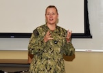 JOINT BASE SAN ANTONIO-FORT SAM HOUSTON – (Nov. 13, 2024) – Capt. Jennifer Buechel, Nurse Corps, of Woodhaven, Mich., commanding officer, Naval Medical Research Unit (NAMRU) San Antonio, addresses research scientists and support staff during the 10th Edition of Mission Possible, an information-sharing event, held at the Tri-Service Research Laboratory. The purpose of Mission Possible is to better inform members of the command on the tactics, techniques, and procedures of the science directorates to include the resource acquisitions and administrative directorates.  NAMRU San Antonio’s mission is to conduct gap driven combat casualty care, craniofacial, and directed energy research to improve survival, operational readiness, and safety of Department of Defense (DoD) personnel engaged in routine and expeditionary operations. It is one of the leading research and development laboratories for the U.S. Navy under the DoD and is one of eight subordinate research commands in the global network of laboratories operating under the Naval Medical Research Command in Silver Spring, Md. (U.S. Navy photo by Burrell Parmer, NAMRU San Antonio Public Affairs/Released)