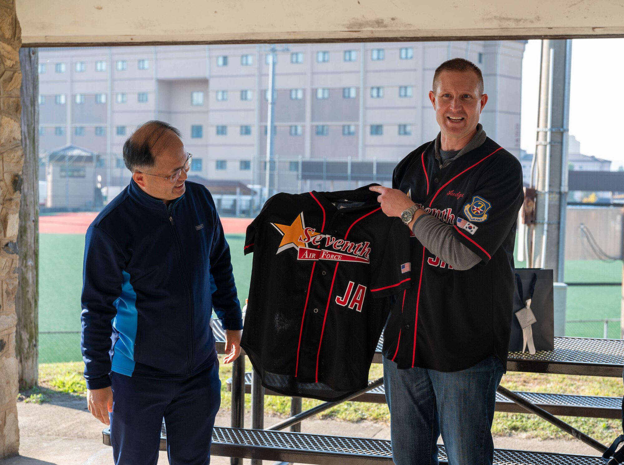 U.S. Air Force Col. Reagan Beaton, 7th Air Force staff judge advocate, exchanges gifts with Republic of Korea Air Force Col. Su Dong Lee, Headquarters ROKAF staff judge advocate, during the annual legal friendship day at Osan Air Base, ROK, Nov. 7, 2024. The two nations have fostered a strong partnership through cultural gift exchanges, symbolizing their shared commitment to mutual defense, respect, and cooperation, which strengthens their alliance and enhances cross-cultural understanding. (U.S. Air Force photo by Staff Sgt. Christopher Tam)