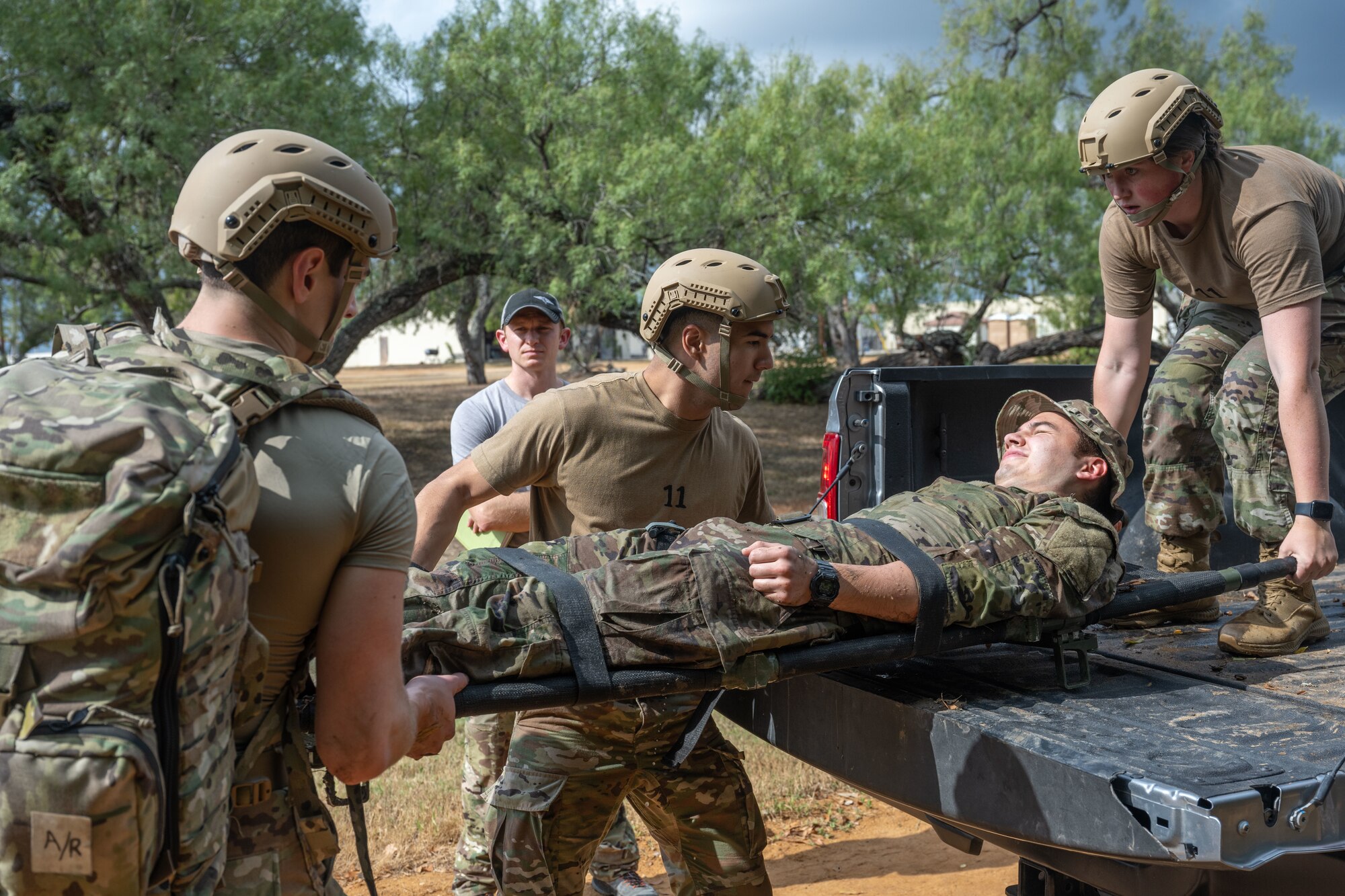 AFROTC cadets move a simulated patient into the bed of a truck