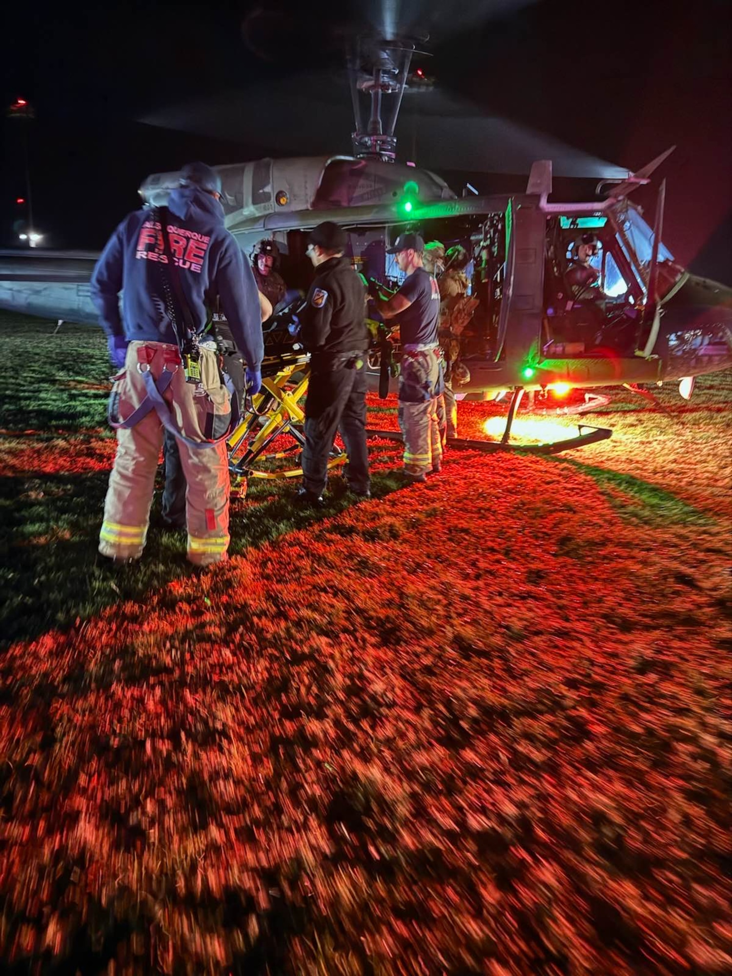 Photo of injured hiker being transferred to hospital staff