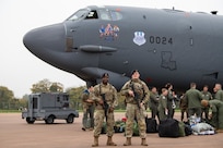 Airmen pose for a photo outside of a B-52H Stratofortress