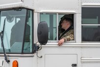 Driver aboard a bus monitors passengers