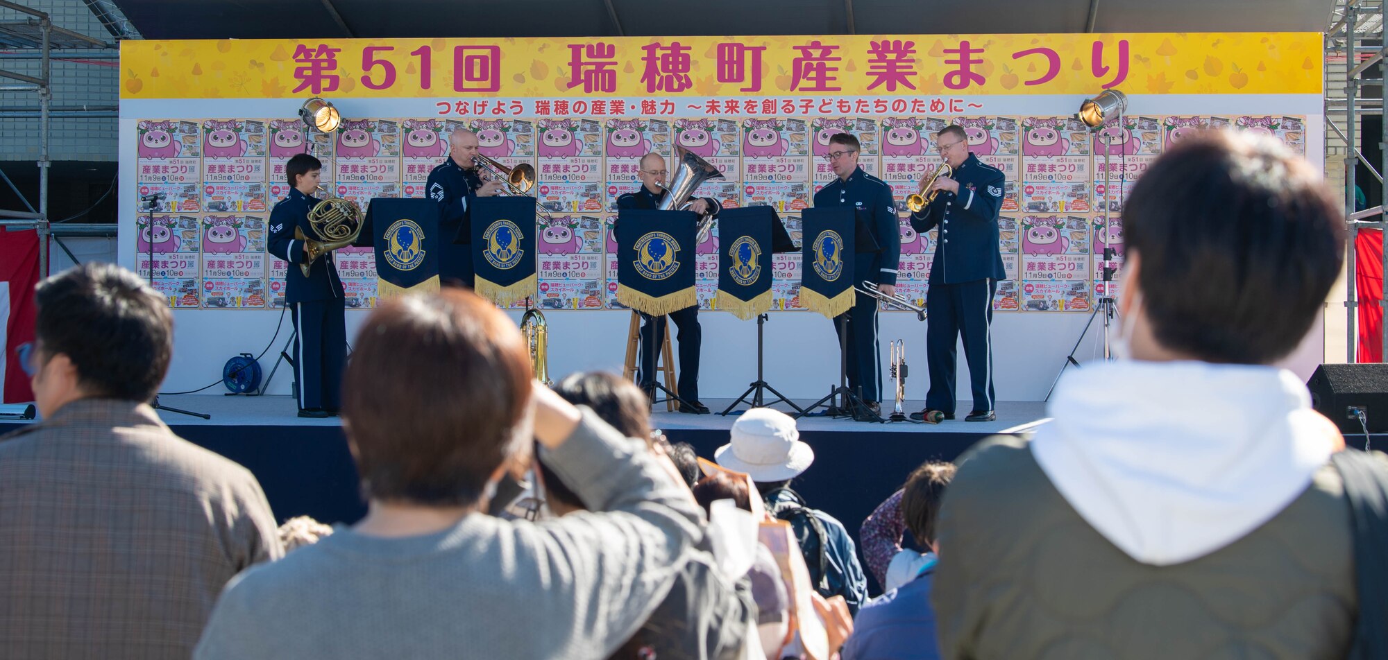 A band performs in front of a crowd.