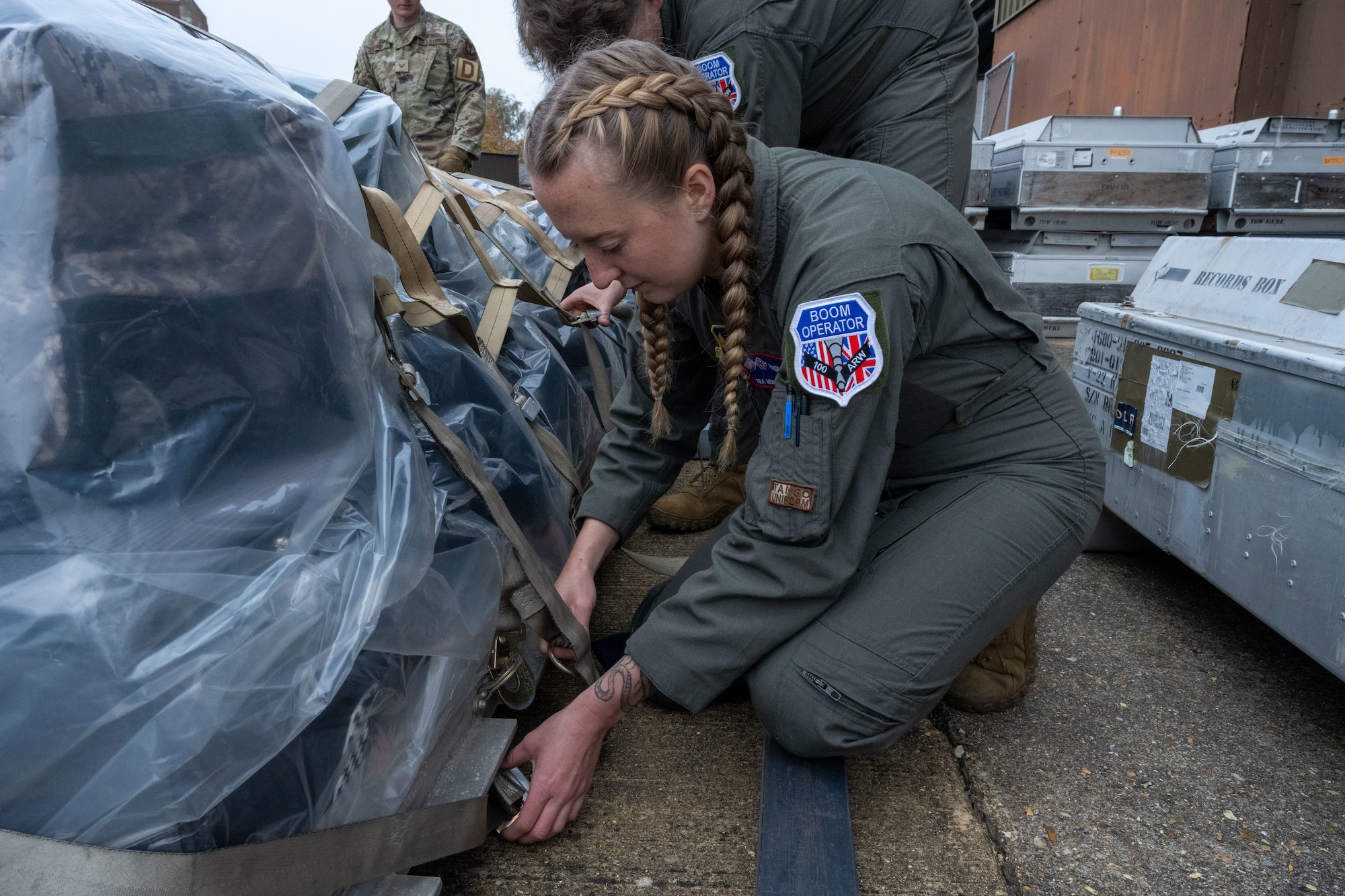 U.S. Air Force Senior Airman Morrigan Denman, 351st Air Refueling Squadron boom operator, secures cargo onto a shipping pallet at Royal Air Force Mildenhall, England, Nov. 5, 2024.
