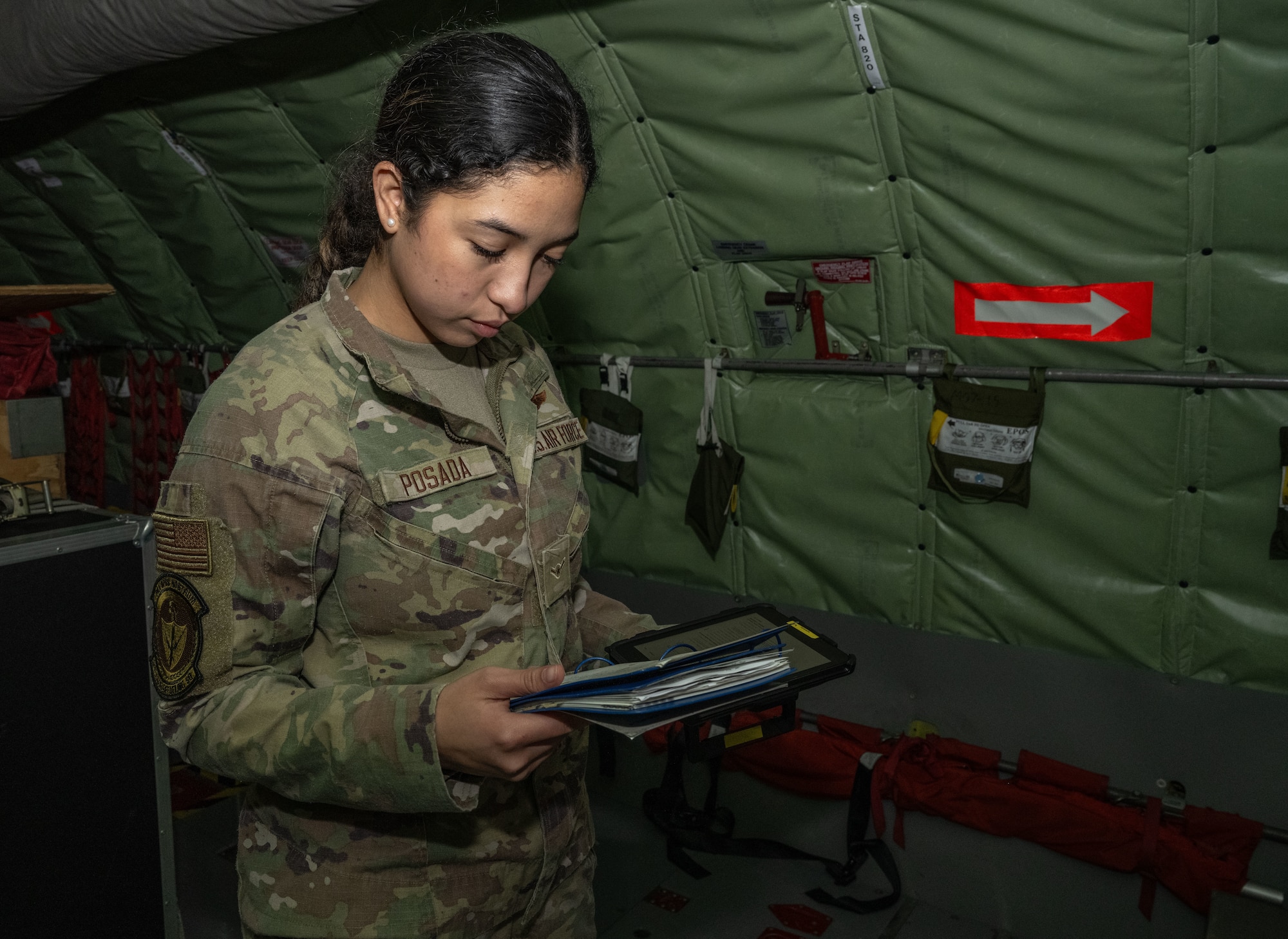 U.S. Air Force Airman Maya Posada, 351st Air Refueling Squadron boom operator, looks over a systems checklist for a KC-135 Stratotanker at Royal Air Force Mildenhall, England, Nov. 5, 2024.