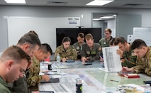 U.S. Airmen collaborate during mission planning for Battalion Mass Tactical Week at Fort Liberty, North Carolina, Nov. 13, 2024.