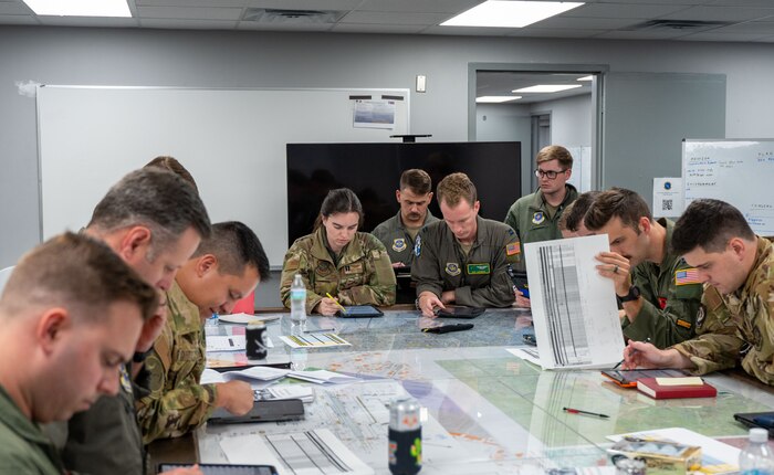 U.S. Airmen collaborate during mission planning for Battalion Mass Tactical Week at Fort Liberty, North Carolina, Nov. 13, 2024.