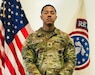 Male Soldier posed in front of the U.S. flag and USAREC flag.