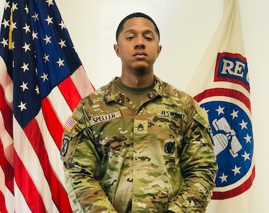 Male Soldier posed in front of the U.S. flag and USAREC flag.