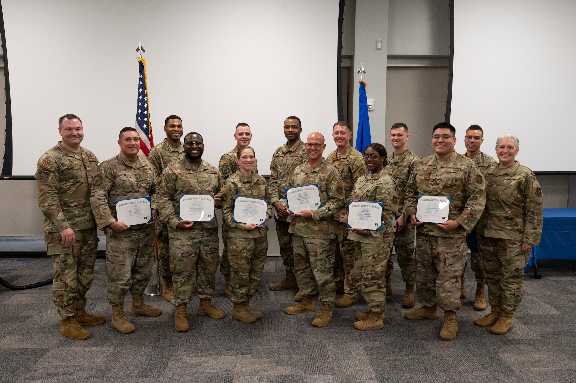 Members stand and pose for a photo.