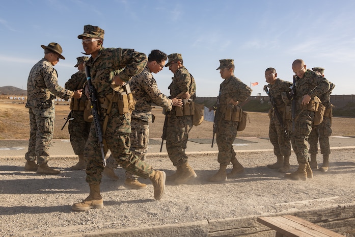 U.S. Marine Corps recruits with Kilo Company, 3rd Recruit Training Battalion, have their gear checked during the table one course of fire at Marine Corps Base Camp Pendleton, California, Nov. 6, 2024. Table one covers the basic fundamentals of marksmanship and rifle safety in all shooting positions: sitting, kneeling, and the prone. (U.S. Marine Corps photo by Lance Cpl. Janell B. Alvarez)