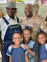 Male Soldier with father and three daughters