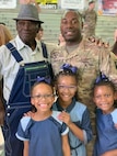 Male Soldier with father and three daughters