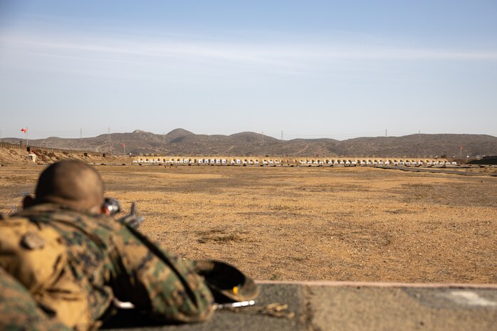 A U.S. Marine Corps recruit with Kilo Company, 3rd Recruit Training Battalion, sights in at a target during the table one course of fire at Marine Corps Base Camp Pendleton, California, Nov. 6, 2024. Table one covers the basic fundamentals of marksmanship and rifle safety in all shooting positions: sitting, kneeling, and the prone. (U.S. Marine Corps photo by Lance Cpl. Janell B. Alvarez)