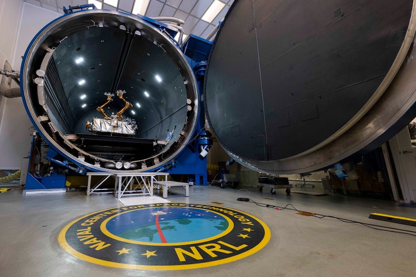 A robot is inside an open cylindrical chamber.