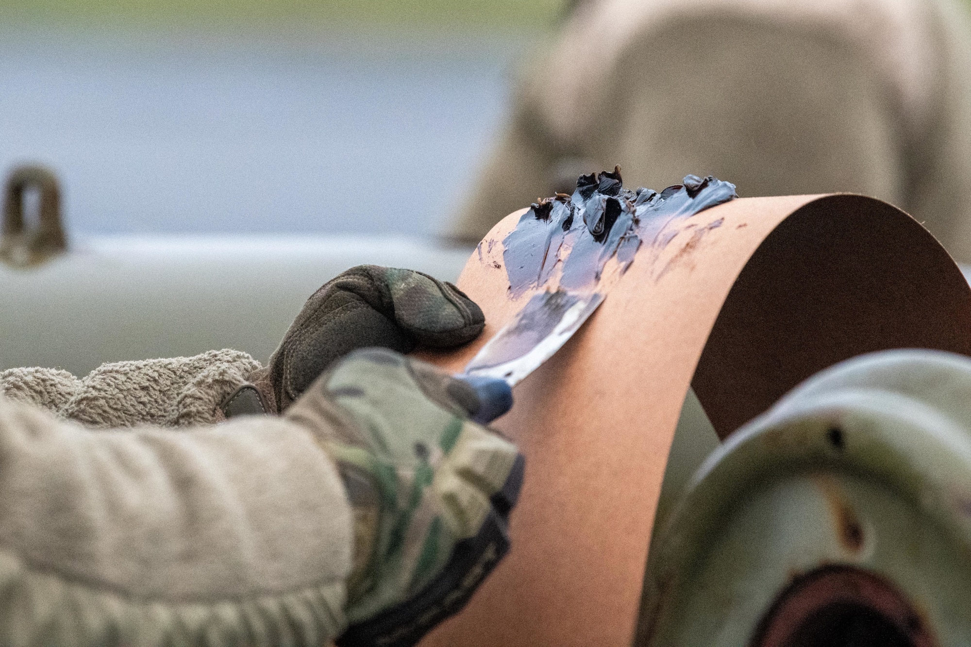 Airman clears excess inert filler from GBU-38 Joint Direct Attack Munitions
