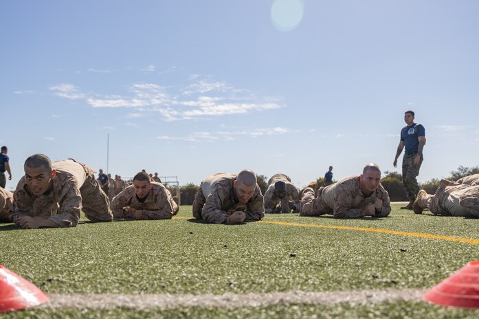 U.S. Marine Corps recruits with Lima Company, 3rd Recruit Training Battalion, execute low crawls during the maneuver under fire portion of the combat fitness test event at Marine Corps Recruit Depot San Diego, California, Oct. 30, 2024. The CFT is a test that all recruits must pass and maintain once a year to assess combat readiness as well as physical conditioning. (U.S. Marine Corps photo by Lance Cpl. Janell B. Alvarez)