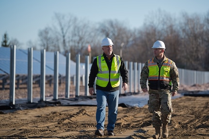 U.S. Air Force Capt. Dayton Brown, right, the base civil engineer, and Robert Letourneau, the base engineering technician, walk the grounds of the solar array expansion at the Vermont Air National Guard Base, South Burlington, Vermont, Nov. 15, 2024. The Vermont Air National Guard began the third and final phase of a photovoltaic power project to increase energy resilience, reduce carbon emissions and enhance emergency readiness.