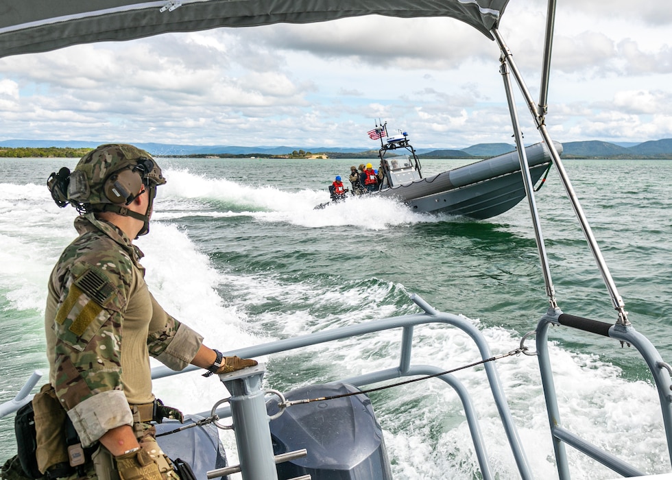 Coast Guardsmen from USS St. Louis (LCS 19) perform maneuvers with Sailors from Naval Station Guantanamo Bay Harbor Patrol.