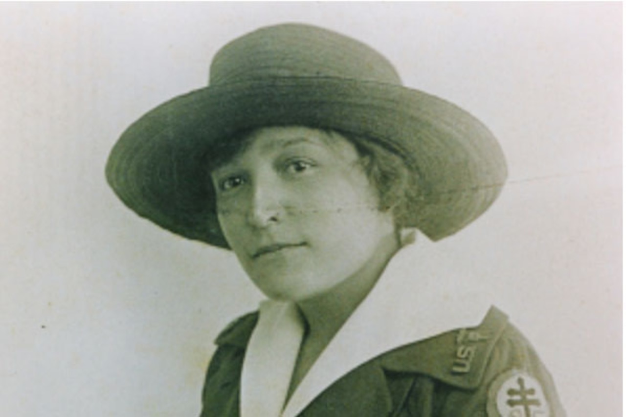 A female soldier poses for a photo.