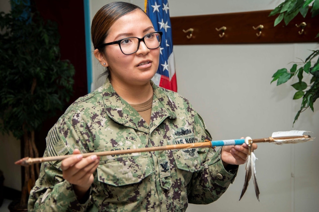 A sailor holds an arrow.